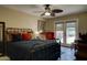 Bedroom featuring a large bed, ceiling fan, and access to the backyard pool at 5431 E Piping Rock Rd, Scottsdale, AZ 85254