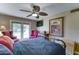 Cozy bedroom with ceiling fan, patio access, and a view of the pool, creating a serene retreat at 5431 E Piping Rock Rd, Scottsdale, AZ 85254