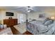 Primary bedroom with hardwood floors, decorative furniture, and fan at 5431 E Piping Rock Rd, Scottsdale, AZ 85254