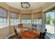 Bright breakfast nook featuring hardwood floors, breakfast table, and windows at 5431 E Piping Rock Rd, Scottsdale, AZ 85254