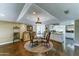 Charming dining room with glass table, designer rug, and wine storage, adjacent to the kitchen at 5431 E Piping Rock Rd, Scottsdale, AZ 85254