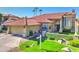 Inviting home exterior with a red tile roof, lush landscaping, and a well-maintained front yard with green grass at 5431 E Piping Rock Rd, Scottsdale, AZ 85254