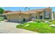 Beautiful single-Gathering home featuring a meticulously landscaped front yard with green grass at 5431 E Piping Rock Rd, Scottsdale, AZ 85254
