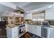 Kitchen featuring stainless appliances, stone countertops, tile backsplash, and white cabinets at 5431 E Piping Rock Rd, Scottsdale, AZ 85254