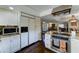 Kitchen featuring stainless appliances, stone countertops, tile backsplash, white cabinets and a tile floor at 5431 E Piping Rock Rd, Scottsdale, AZ 85254
