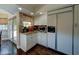 Bright kitchen featuring granite countertops, white cabinets, stainless steel appliances, and a glass door at 5431 E Piping Rock Rd, Scottsdale, AZ 85254