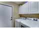 Laundry room with modern washer and dryer, and storage above at 5431 E Piping Rock Rd, Scottsdale, AZ 85254