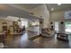Open floor plan with dark wood flooring, a step-down living room, dining room, and partial view of the kitchen at 5431 E Piping Rock Rd, Scottsdale, AZ 85254