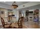 Beautiful living room with fireplace, chandelier, hardwood floors and dining area with glass table at 5431 E Piping Rock Rd, Scottsdale, AZ 85254