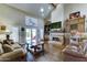 Spacious living room featuring a vaulted ceiling, fireplace, recessed lighting, and french doors at 5431 E Piping Rock Rd, Scottsdale, AZ 85254