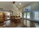 Open floor plan with dark wood flooring, a step-down living room, dining room, and partial view of the kitchen at 5431 E Piping Rock Rd, Scottsdale, AZ 85254