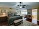 Cozy main bedroom featuring hardwood floors, king bed, fan and ensuite bathroom at 5431 E Piping Rock Rd, Scottsdale, AZ 85254