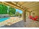 Outdoor patio with poolside seating and lush landscaping at 5431 E Piping Rock Rd, Scottsdale, AZ 85254