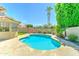 Sparkling pool with travertine surround, lush landscaping, and manicured lawn, perfect for outdoor living at 5431 E Piping Rock Rd, Scottsdale, AZ 85254