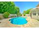 Private backyard pool with travertine patio, surrounded by lush greenery and palm trees, ideal for relaxation at 5431 E Piping Rock Rd, Scottsdale, AZ 85254