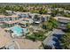 Aerial view showcasing the community pool, tennis court, landscaping, and buildings at 600 W Grove Pkwy # 2188, Tempe, AZ 85283