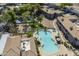 Aerial view showcasing the swimming pool, hot tub, tennis court, and lush landscaping of the community at 600 W Grove Pkwy # 2188, Tempe, AZ 85283