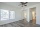 Bright bedroom featuring a ceiling fan, wood-look flooring, and large windows for ample natural light at 600 W Grove Pkwy # 2188, Tempe, AZ 85283