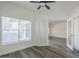 Corner bedroom featuring wood-look flooring, a ceiling fan and large window with lots of light at 600 W Grove Pkwy # 2188, Tempe, AZ 85283