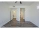Bright bedroom featuring a ceiling fan, wood-look flooring, and access to a bathroom at 600 W Grove Pkwy # 2188, Tempe, AZ 85283