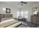 Cozy bedroom featuring wood-look flooring, a ceiling fan, and light and airy decor at 600 W Grove Pkwy # 2188, Tempe, AZ 85283