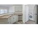 The kitchen features stainless steel appliances and light cabinets with a laundry closet at 600 W Grove Pkwy # 2188, Tempe, AZ 85283