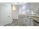Kitchen view featuring stainless steel sink and modern cabinets with open living area at 600 W Grove Pkwy # 2188, Tempe, AZ 85283