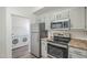 The kitchen features stainless steel appliances with laundry closet access at 600 W Grove Pkwy # 2188, Tempe, AZ 85283