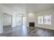 Living room featuring gray wood-look floors, fireplace and plenty of natural light at 600 W Grove Pkwy # 2188, Tempe, AZ 85283