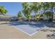 Community tennis court surrounded by beautiful trees, offering a recreational amenity at 600 W Grove Pkwy # 2188, Tempe, AZ 85283