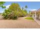 Expansive backyard featuring gravel landscaping, artificial turf, and mature trees at 8411 E Via De Jardin --, Scottsdale, AZ 85258