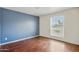 Bedroom featuring laminate floors and large window letting in ample light at 8411 E Via De Jardin --, Scottsdale, AZ 85258