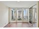 Bedroom featuring hardwood floors, sliding mirror door closet, and view of an atrium at 8411 E Via De Jardin --, Scottsdale, AZ 85258