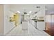 Spacious kitchen boasts tiled floors, white cabinets, an island cooktop, and stainless steel appliances at 8411 E Via De Jardin --, Scottsdale, AZ 85258