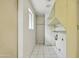 Tiled laundry room with built-in shelving and a window for natural light at 8411 E Via De Jardin --, Scottsdale, AZ 85258