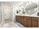 Bathroom featuring dual sinks, white countertops, wood cabinets, and tile flooring at 955 E Knox Rd # 126, Chandler, AZ 85225