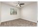 Bedroom features neutral carpet, white walls, ceiling fan, and shuttered windows at 955 E Knox Rd # 126, Chandler, AZ 85225