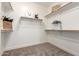Walk-in closet with carpeted floor and wood shelving at 955 E Knox Rd # 126, Chandler, AZ 85225