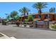 Savona community entrance featuring a stone sign, mature palm trees and well maintained landscaping at 955 E Knox Rd # 126, Chandler, AZ 85225