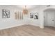 Cozy dining area with wood-look floors, white plantation shutters, and a decorative modern light fixture at 955 E Knox Rd # 126, Chandler, AZ 85225