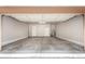 Clean, empty garage with painted walls, concrete floors and door to the house at 955 E Knox Rd # 126, Chandler, AZ 85225