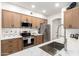 Modern kitchen featuring stainless steel appliances, stylish wood cabinets, and sleek white countertops at 955 E Knox Rd # 126, Chandler, AZ 85225