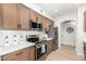 Updated kitchen featuring stainless steel appliances, quartz countertops, and wood cabinetry at 955 E Knox Rd # 126, Chandler, AZ 85225