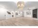 Spacious living room with wood-look tile floors, modern lighting fixture, and an inviting open-concept layout at 955 E Knox Rd # 126, Chandler, AZ 85225