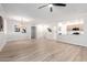 Open-concept living room with wood-look floors, modern lighting, and seamless flow to the kitchen at 955 E Knox Rd # 126, Chandler, AZ 85225