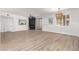 Bright living room featuring wood-look floors, a fireplace, and a large window with plantation shutters at 955 E Knox Rd # 126, Chandler, AZ 85225