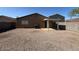 Spacious backyard featuring low-maintenance landscaping and a covered patio, perfect for outdoor entertaining and relaxation at 990 E Desert Rose Trl, San Tan Valley, AZ 85143