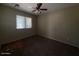 Inviting bedroom featuring a ceiling fan and a bright window, offering a comfortable space at 990 E Desert Rose Trl, San Tan Valley, AZ 85143