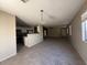 Open-concept living room boasting plenty of natural light and seamless flow into the kitchen area at 990 E Desert Rose Trl, San Tan Valley, AZ 85143