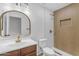 Modern bathroom with a wooden vanity, white subway tiles, and sleek brass fixtures at 1405 E Chicago Cir, Chandler, AZ 85225